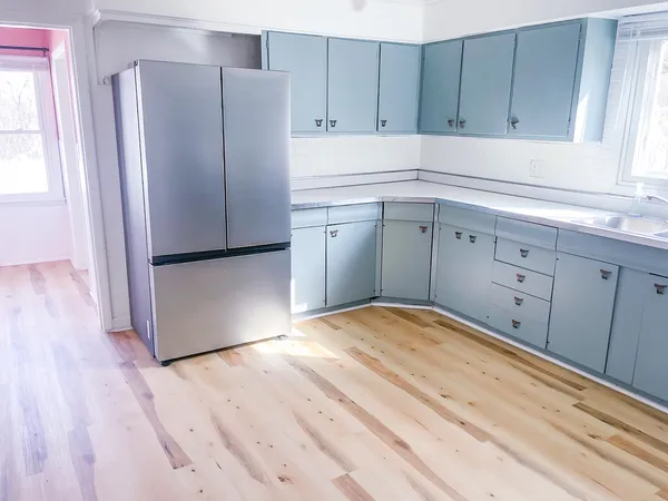 a kitchen with a refrigerator and cabinets