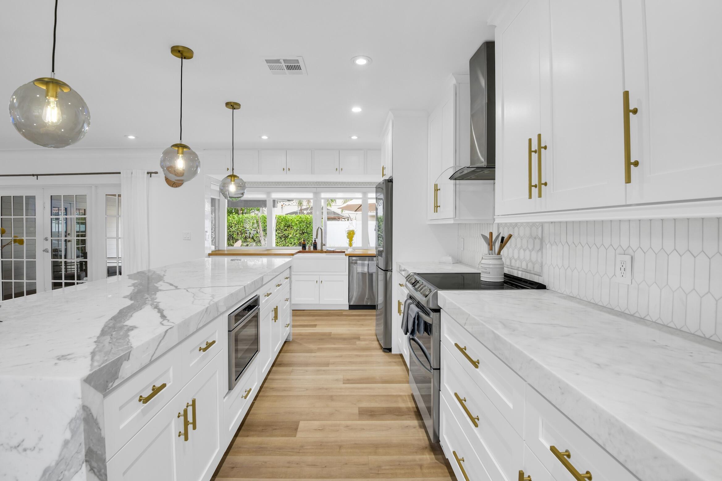 701 Appleby Street Boca Raton, FL 33487 - Photo 7 of 47 a large kitchen with stainless steel appliances lots of counter space wooden floor and a sink