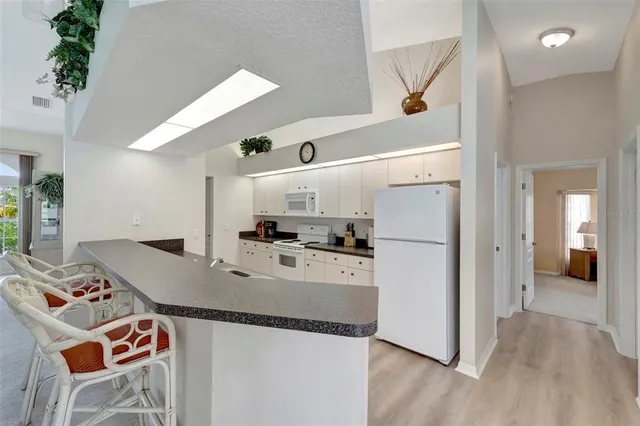 a kitchen with granite countertop a sink and cabinets