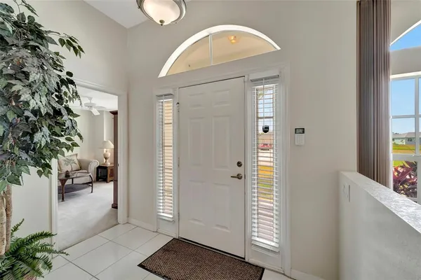 a view of a hallway with wooden floor and a living room