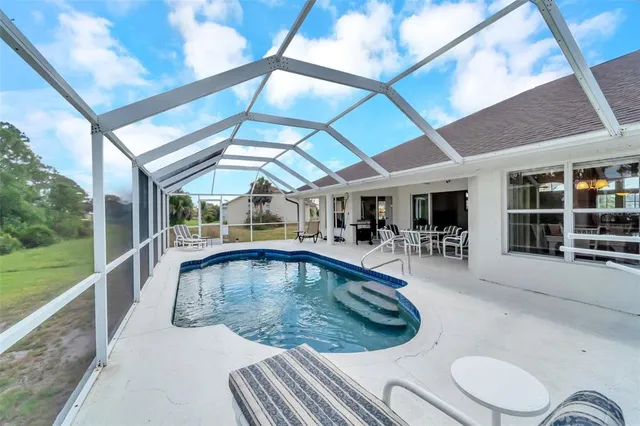 a view of a house with a backyard porch and sitting area