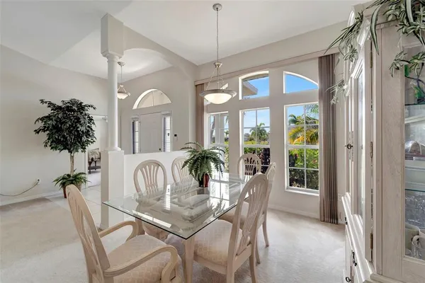 a dining room with furniture garden view and a chandelier