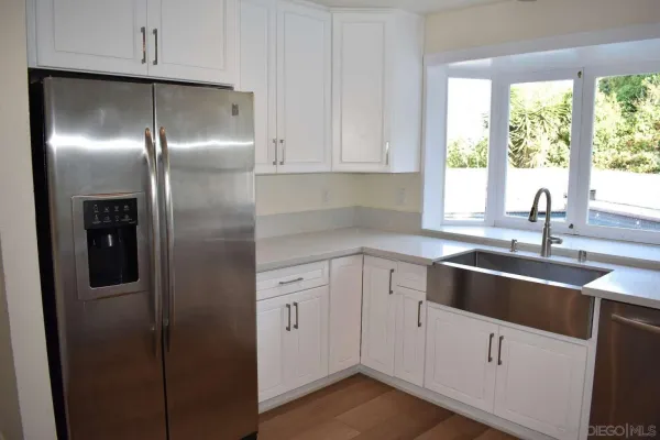 a kitchen with a refrigerator and a sink