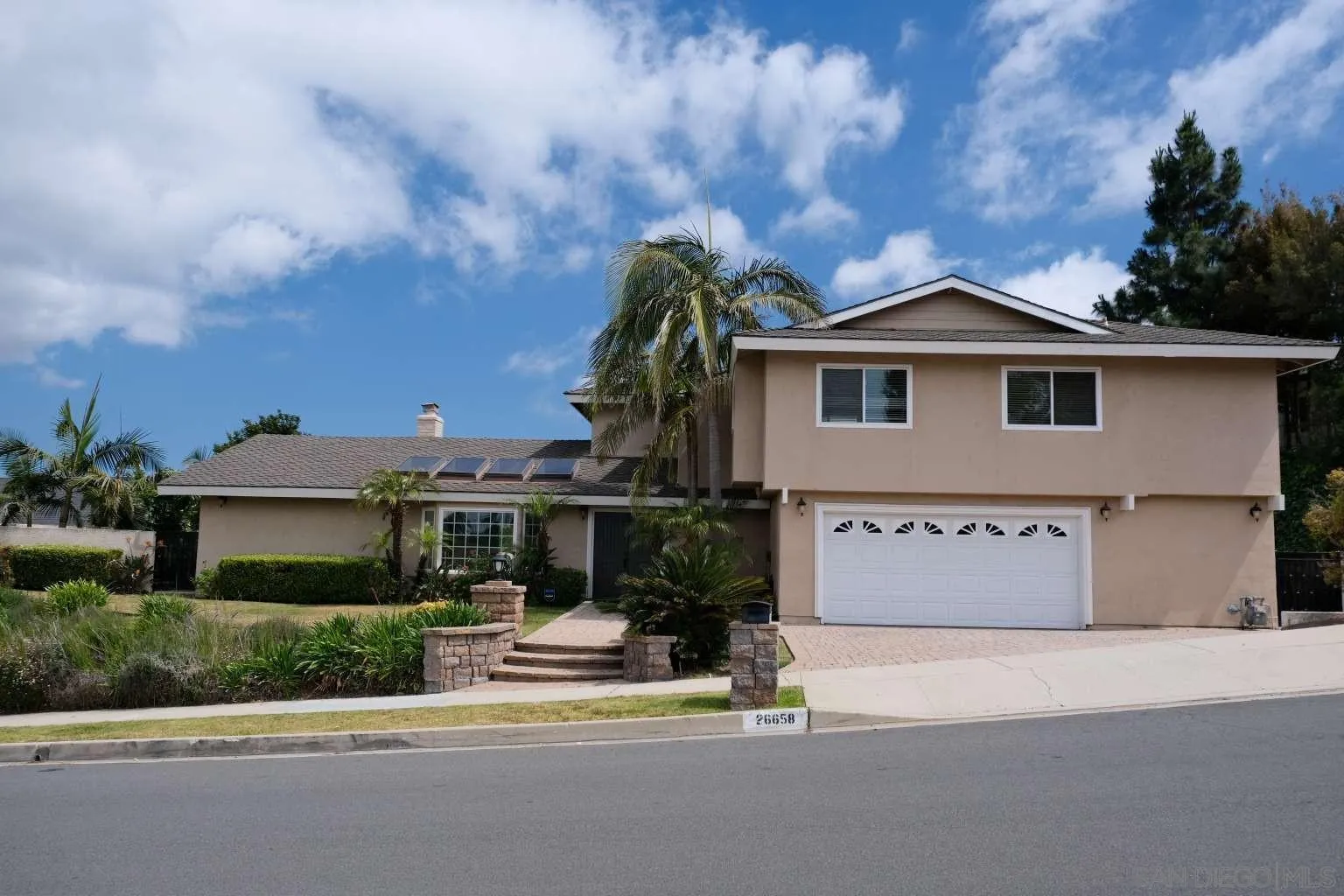 26658 Honey Creek Road Rancho Palos Verdes, CA 90275 - Photo 2 of 38 a front view of a house with a garden and yard