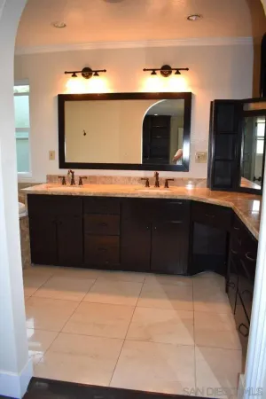 a bathroom with a sink vanity and mirror