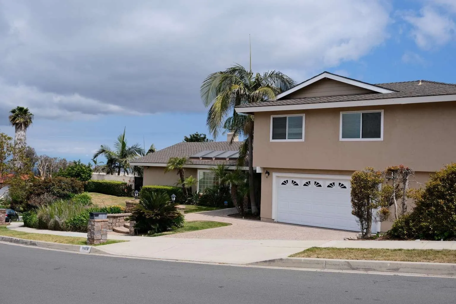 26658 Honey Creek Road Rancho Palos Verdes, CA 90275 - Photo 3 of 38 a front view of a house with a yard and garage