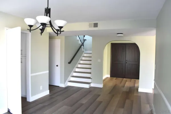 a view of a hallway with wooden floor