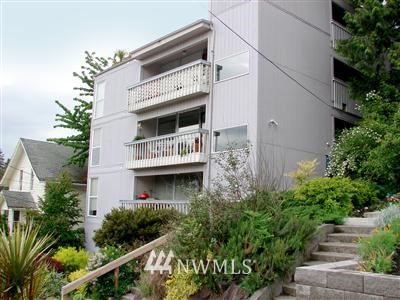 10316 Northeast 187th Street, Unit 302 Bothell, WA 98011 - Photo 1 of 1 a front view of a house with plants