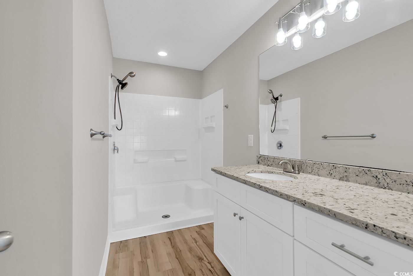 308 Kiskadee Loop, Unit E Conway, SC 29526 - Photo 21 of 36 Full bath with a shower stall, vanity, and light wood finished floors