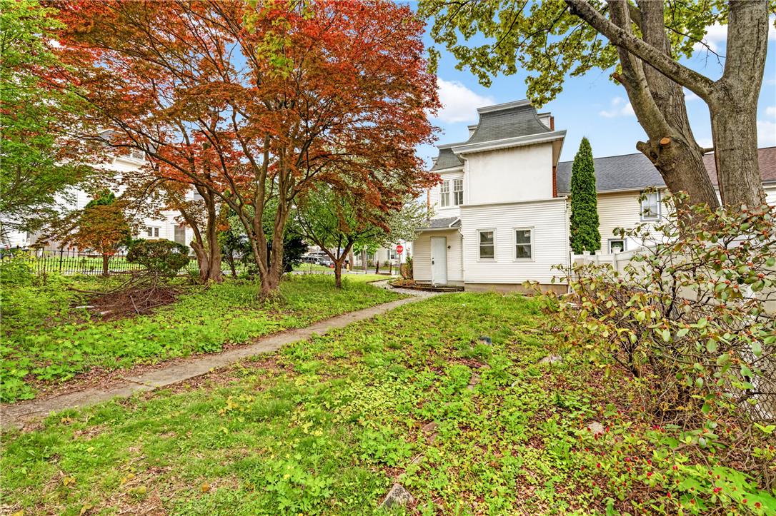 65 2nd Street Slatington, PA 18080 - Photo 45 of 46 A classic structure with a distinctive mansard roof, framed by mature trees and a verdant lawn.