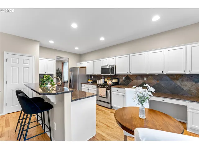 a kitchen with kitchen island granite countertop lots of counter top space and furniture