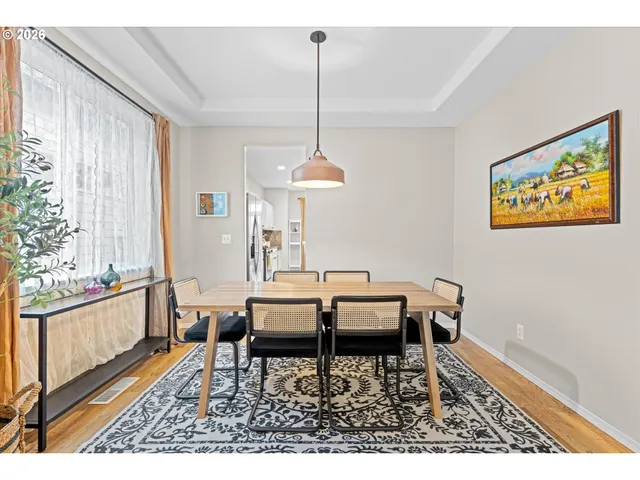 a dining room with furniture and window