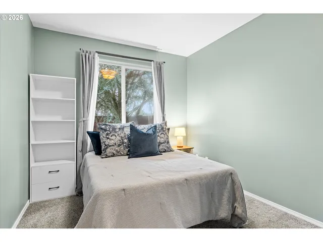 a bedroom with a bed and a window