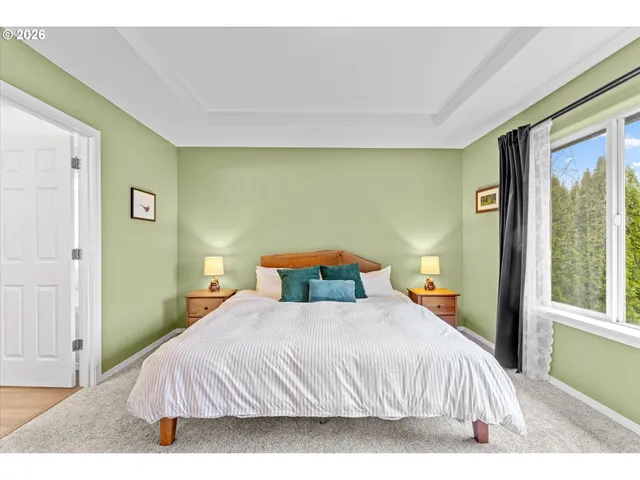 a bedroom with a bed and a large window