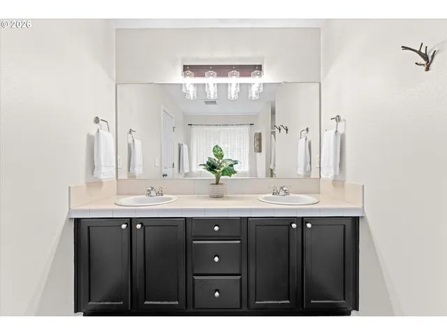 a bathroom with a granite countertop sink a large mirror and a