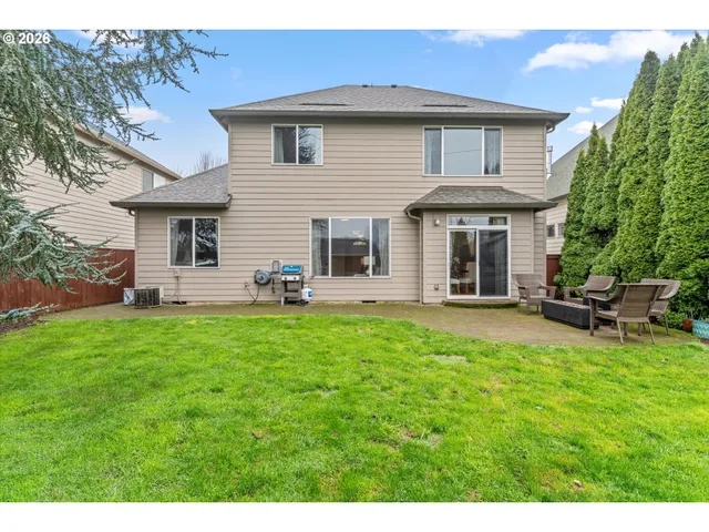 a backyard of a house with table and chairs