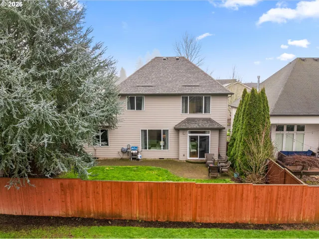 a front view of a house with a yard and trees