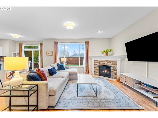 a living room with furniture a flat screen tv and a fireplace