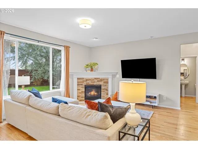 a living room with furniture a fireplace and a flat screen tv