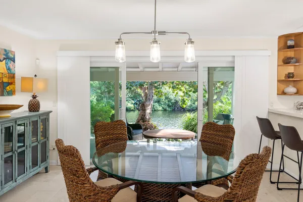 a dining room with furniture a chandelier and window