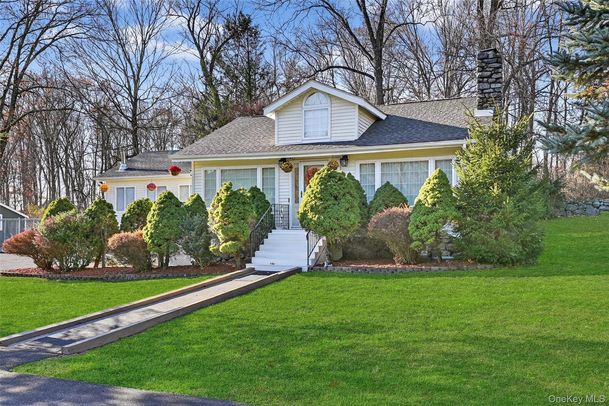 17 Pine Hill Road Highland Mills, NY 10930 - Photo 25 of 43 a front view of a house with a garden