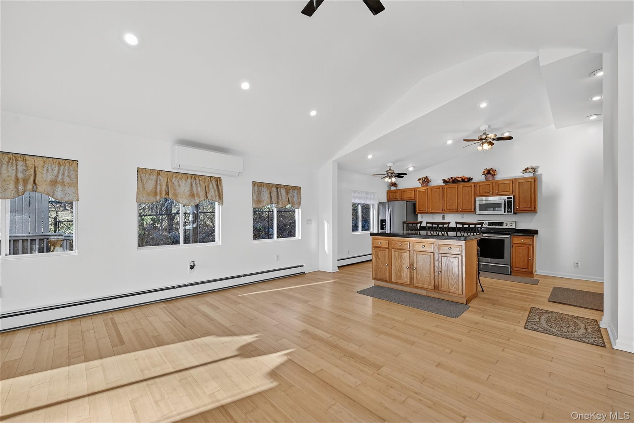 17 Pine Hill Road Highland Mills, NY 10930 - Photo 43 of 43 a living room with stainless steel appliances kitchen island granite countertop a stove a sink a refrigerator and white cabinets with wooden floor