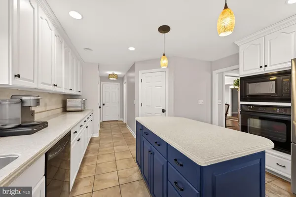 a kitchen with stainless steel appliances a sink a stove a refrigerator and cabinets