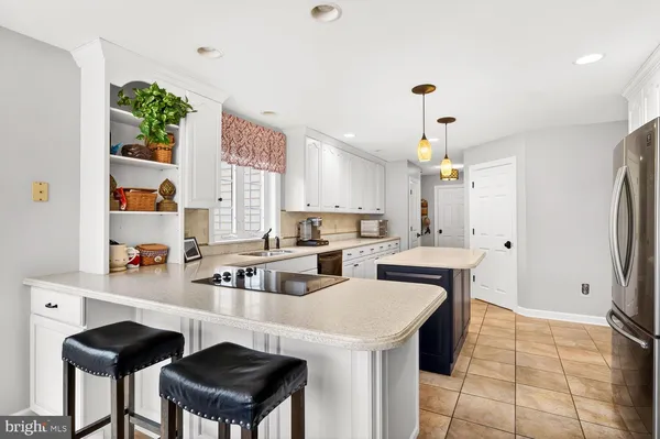 a kitchen with a sink a stove a refrigerator and wooden cabinets