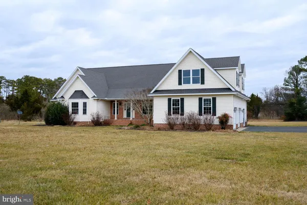 a view of a house with a big yard and sitting area