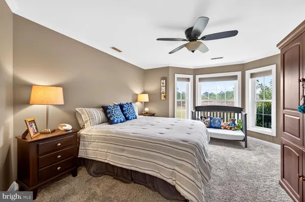 a bedroom with a bed and a ceiling fan