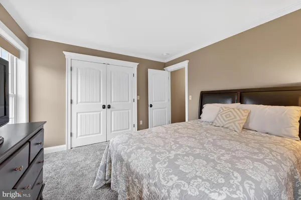 a bedroom with a bed and a television