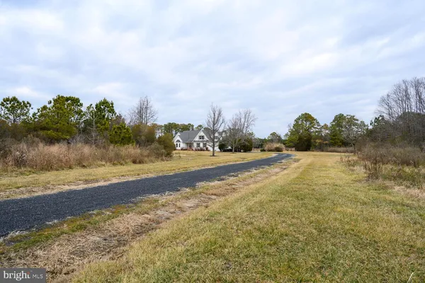a aerial view of a house with a yard table and chairs