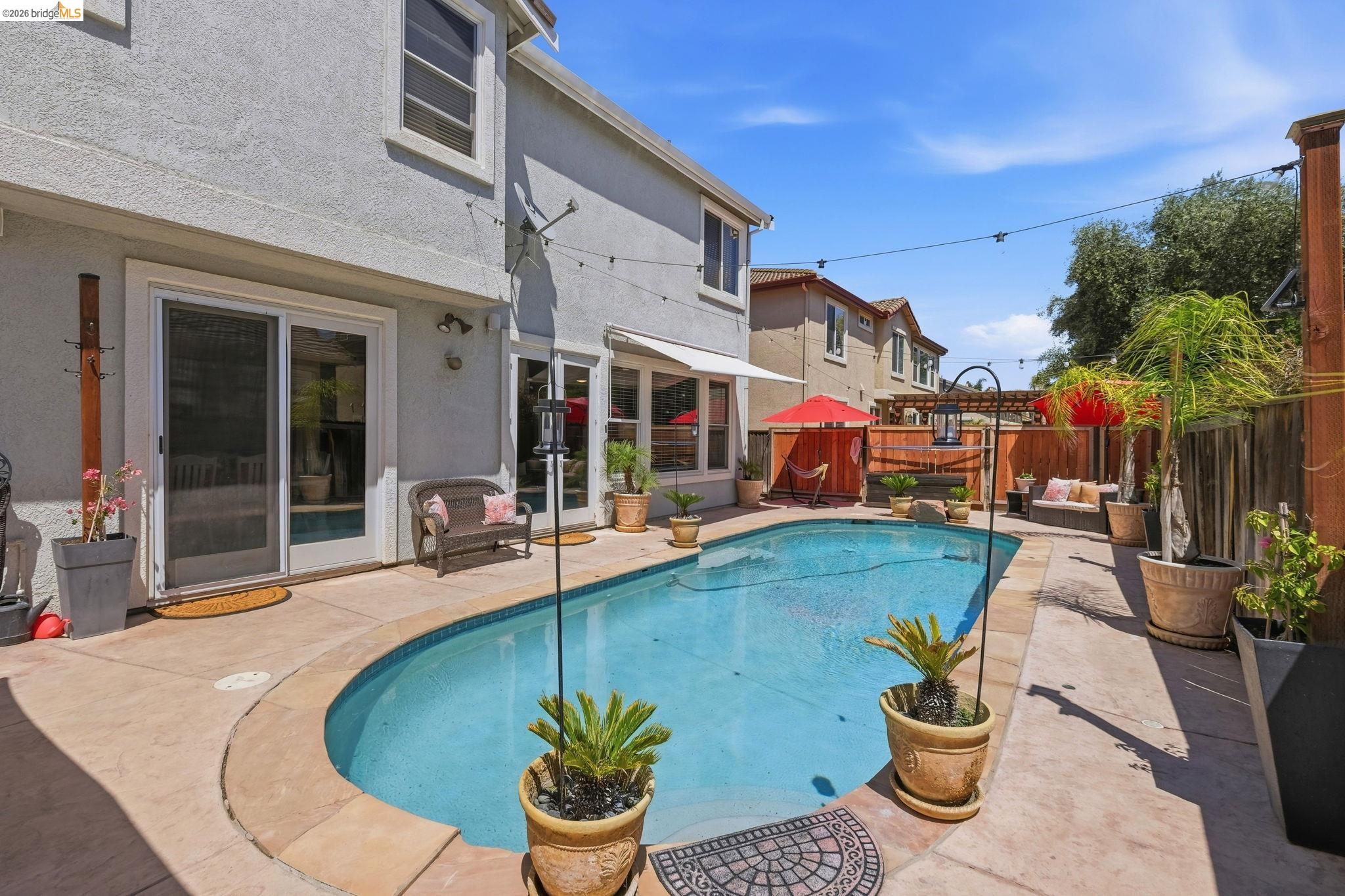 3438 Keystone Loop Discovery Bay, CA 94505 - Photo 44 of 57 a swimming pool with outdoor seating yard and plants