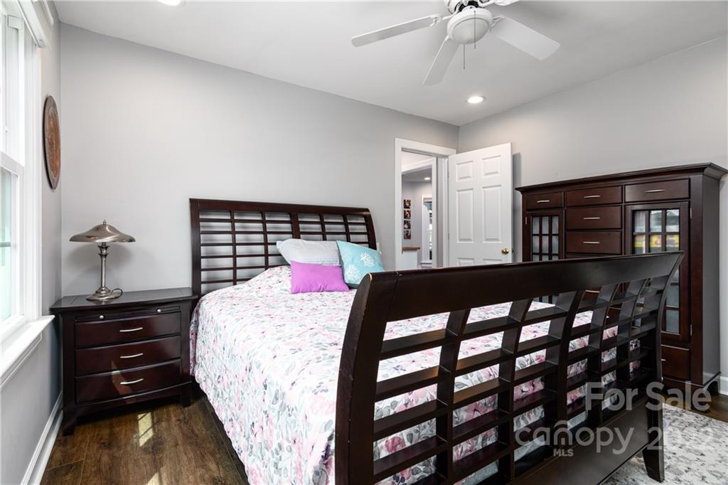 3364 Blue Jay Pass Fort Mill, SC 29708 - Photo 15 of 30 a bedroom with a bed window and a chandelier