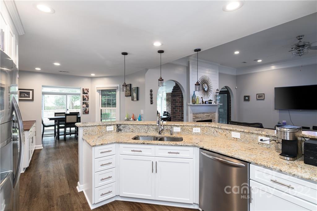 3364 Blue Jay Pass Fort Mill, SC 29708 - Photo 7 of 30 a kitchen with granite countertop a sink stainless steel appliances and white cabinets