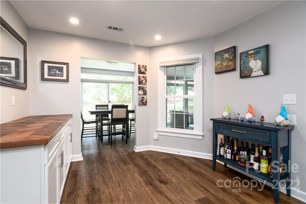 3364 Blue Jay Pass Fort Mill, SC 29708 - Photo 8 of 30 a kitchen with stainless steel appliances granite countertop a stove top oven a dining table and chairs with wooden floor