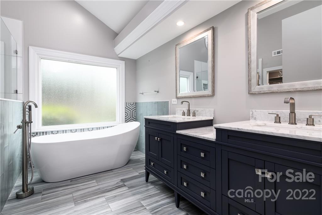 3364 Blue Jay Pass Fort Mill, SC 29708 - Photo 10 of 30 a bathroom with a tub sink double vanity granite and a mirror