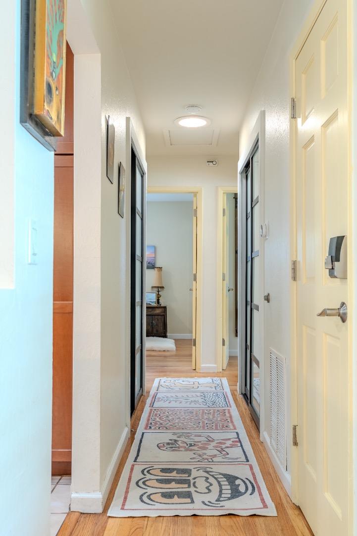 1080 Barcelona Drive Pacifica, CA 94044 - Photo 17 of 48 a view of a hallway with wooden floor and a bathroom