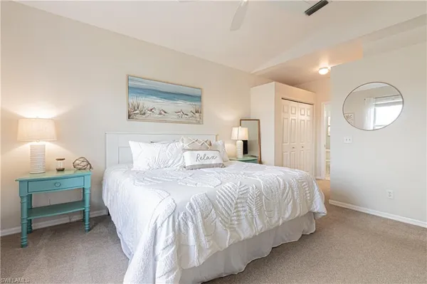 a bedroom with a bed and a lamp