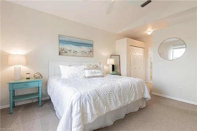 a bedroom with a bed and a lamp