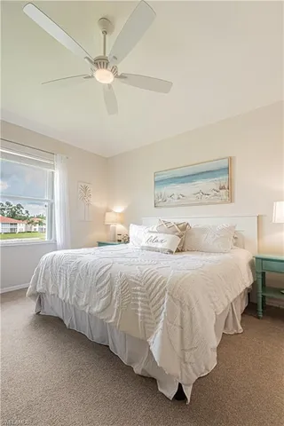 a bedroom with bed and a chandelier