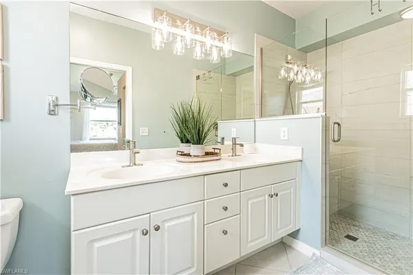 a bathroom with a shower sink and mirror