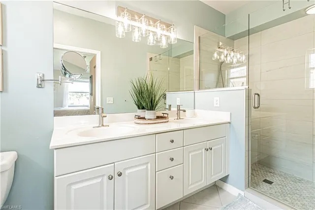 a bathroom with a shower sink and mirror