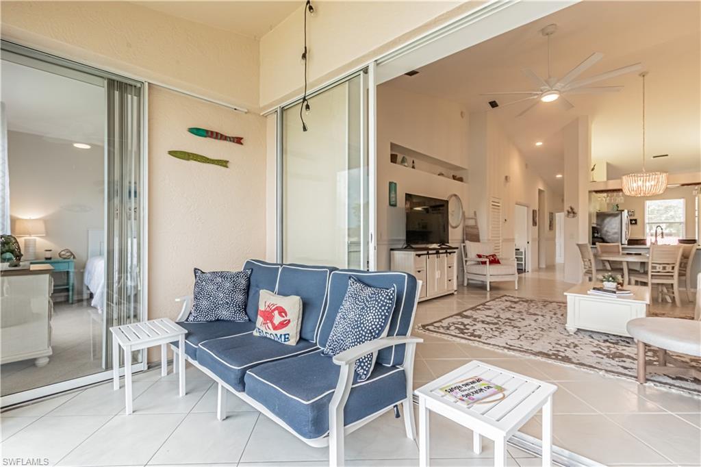 260 Robin Hood Circle, Unit 202 Naples, FL 34104 - Photo 21 of 28 a living room with furniture and a flat screen tv