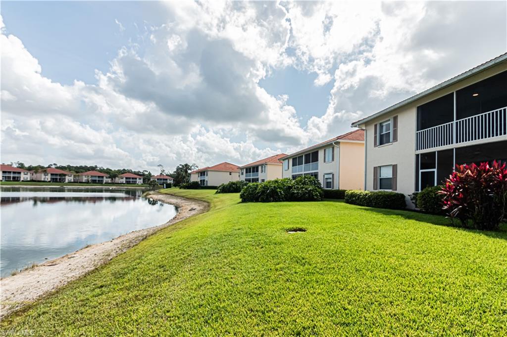 260 Robin Hood Circle, Unit 202 Naples, FL 34104 - Photo 3 of 28 a view of a house with swimming pool and yard