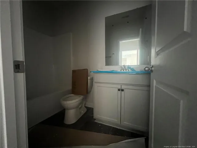 a view of an empty room and window and wooden floor