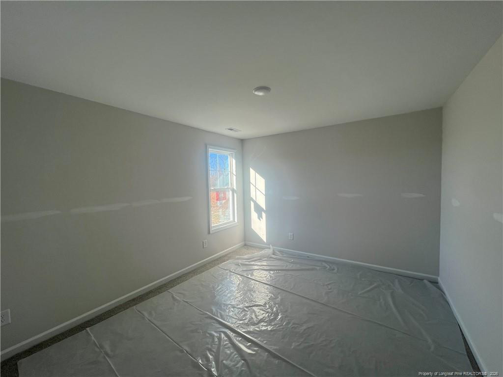 4075 Blue Springs Road Red Springs, NC 28377 - Photo 21 of 28 an empty room with windows and entrance