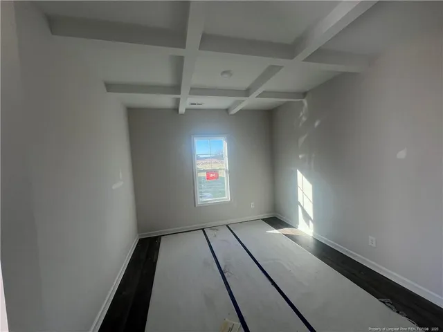 a kitchen with granite countertop a refrigerator and cabinets