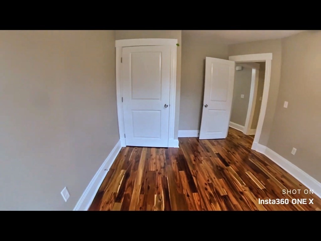 103 Lexington Street, Unit 103 Newton, MA 02466 - Photo 13 of 19 a open area with wooden floor