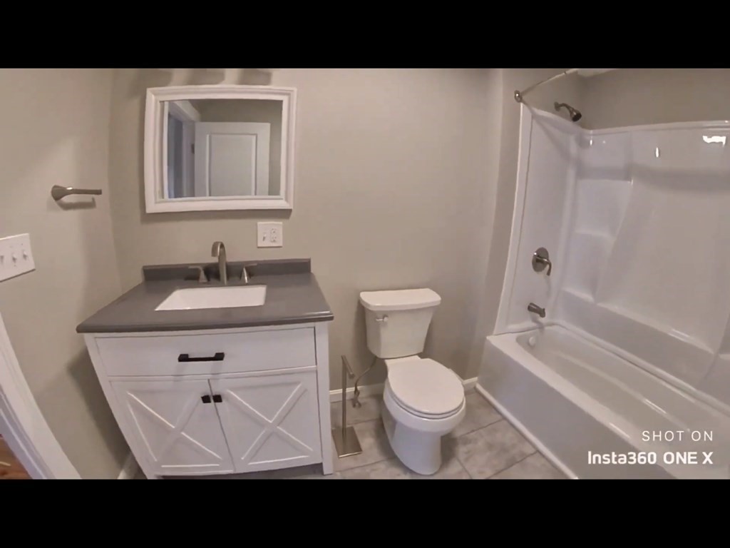 103 Lexington Street, Unit 103 Newton, MA 02466 - Photo 14 of 19 a bathroom with a sink a toilet and a bathtub